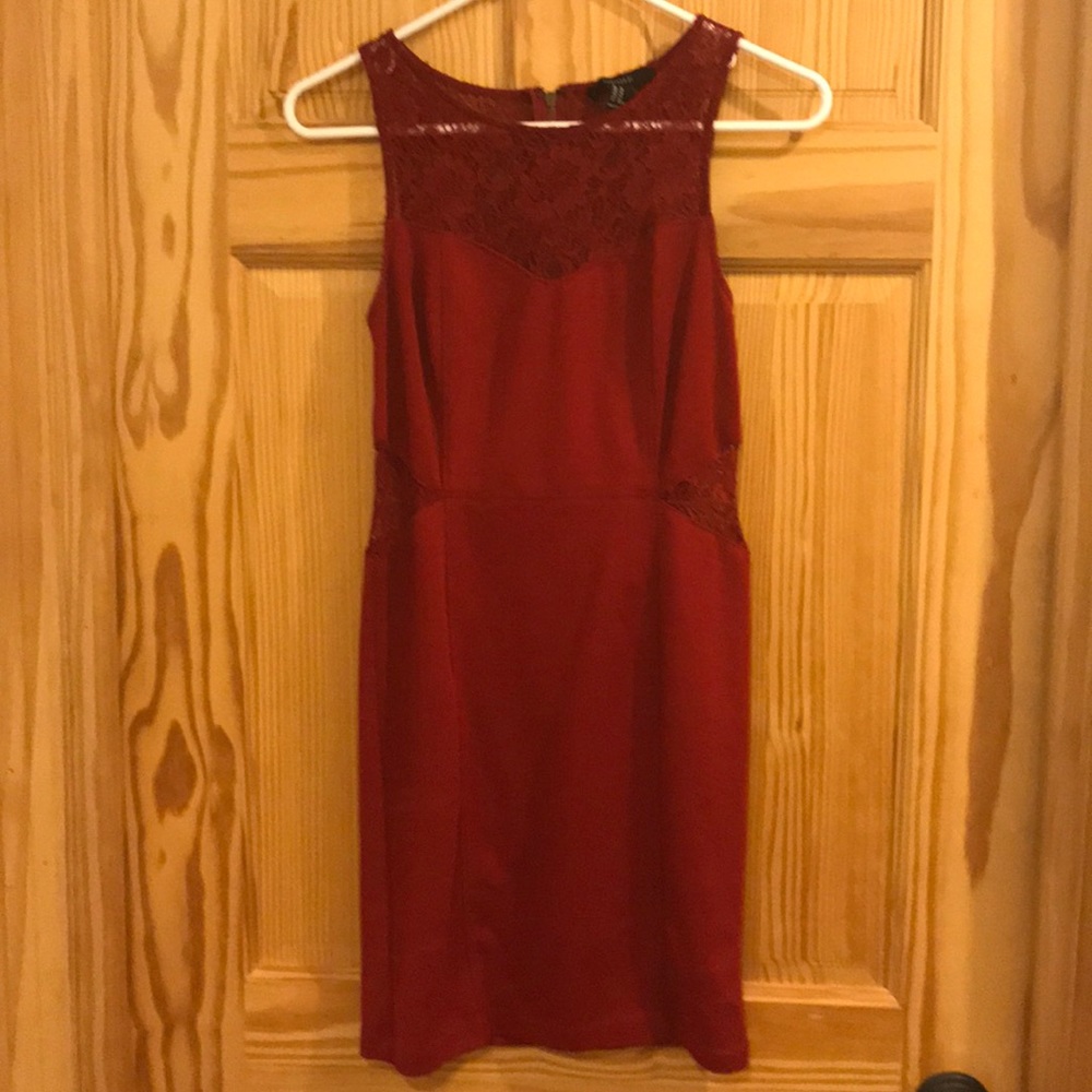 Cute deep red body con dress with lace cutouts